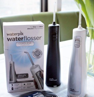 Waterpik Cordless Freedom in black and white; linked option is one black unit